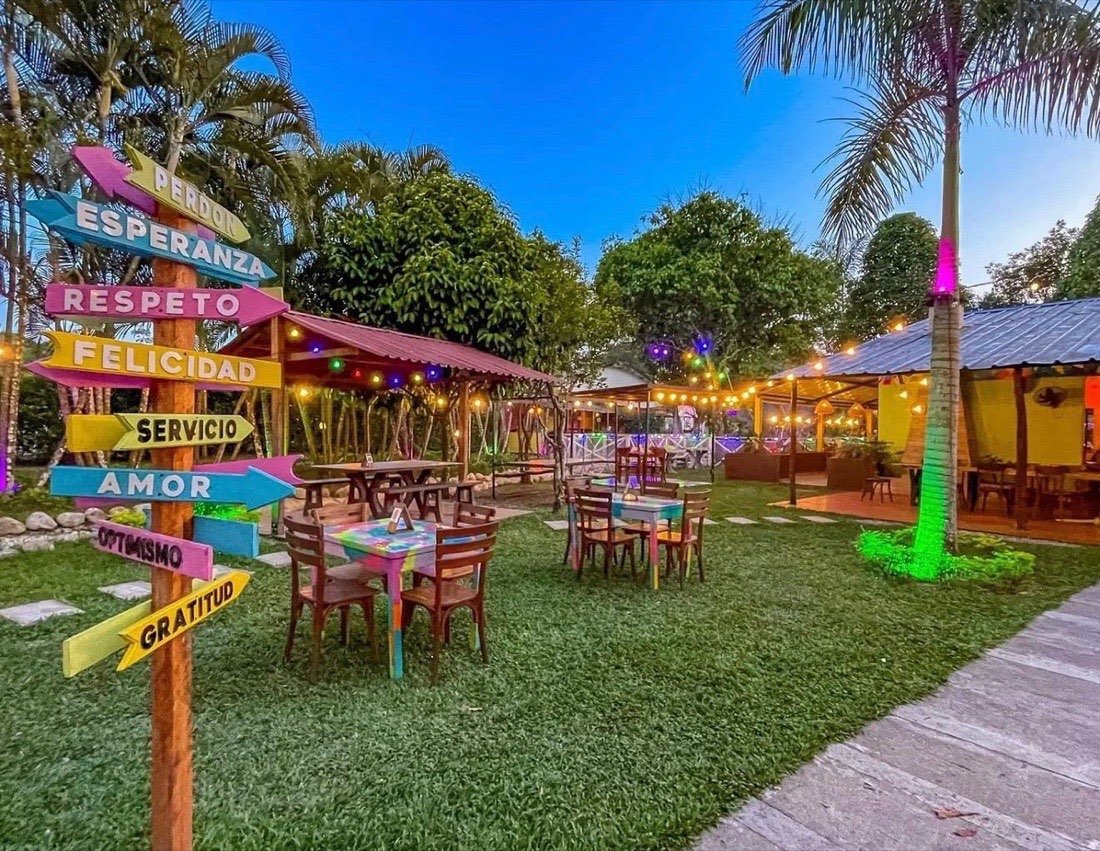 Jardín con letreros de colores al atardecer